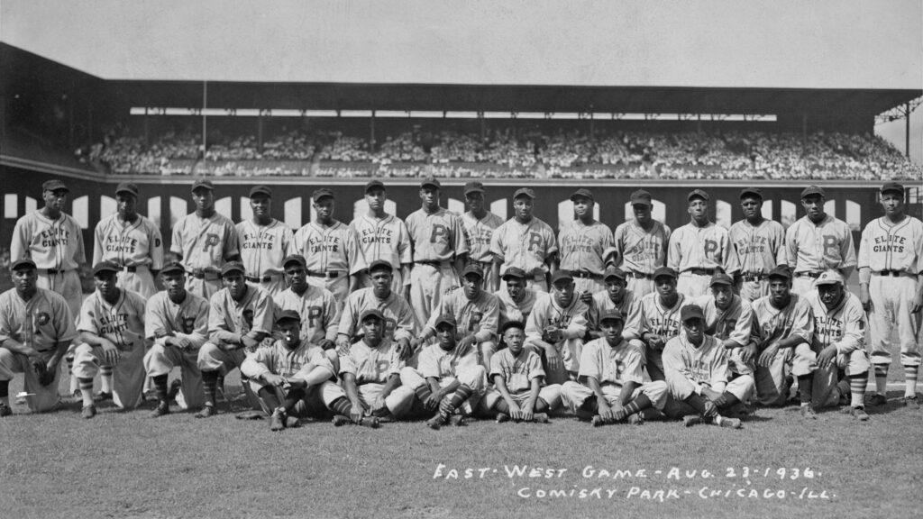 The fourth Negro League All-Star Game, a battle between the best of the East and West at Chicago's Comiskey Park on August 23, 1936. The game featured Baseball Hall of Famers such as Josh Gibson, Satchel Paige, Cool Papa Bell, Willard Brown, and Biz Mackey, each of whom is pictured here.